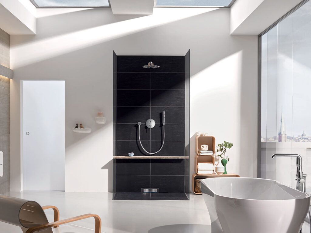 A spacious bathroom with large freestanding tub and open shower.