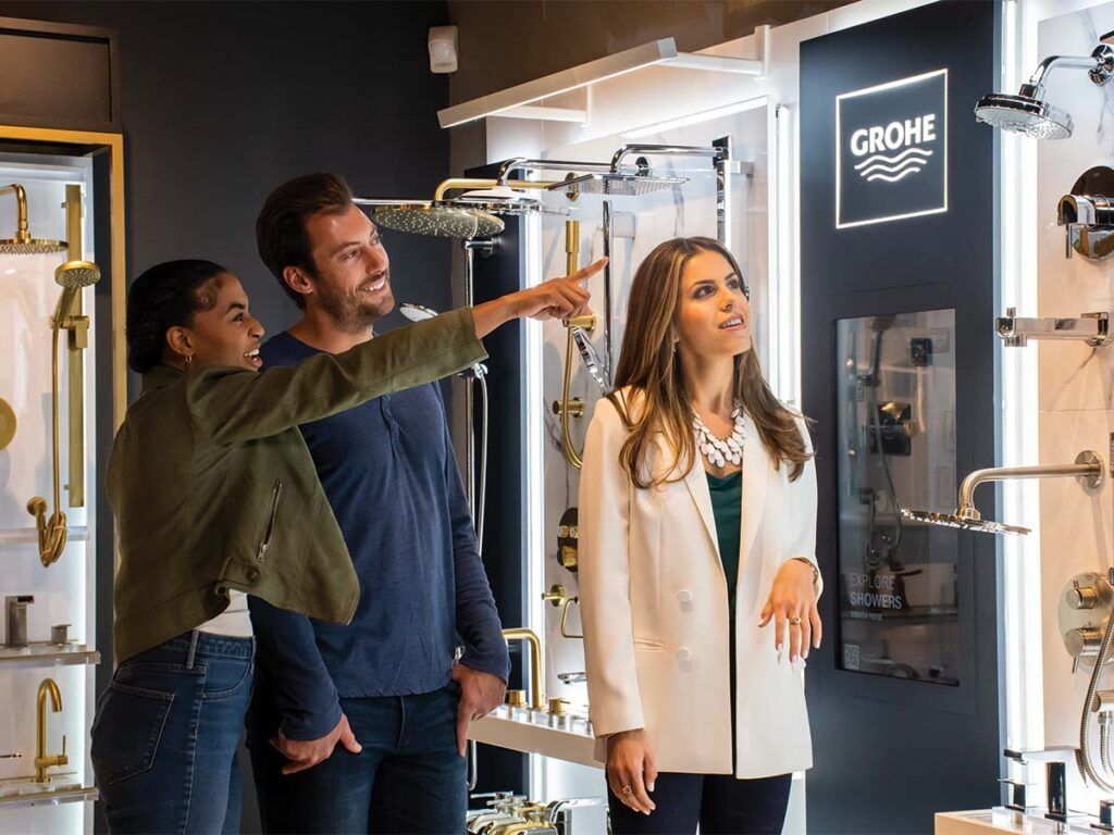 A young couple working with a Studio41 expert picking out fixtures for their home.