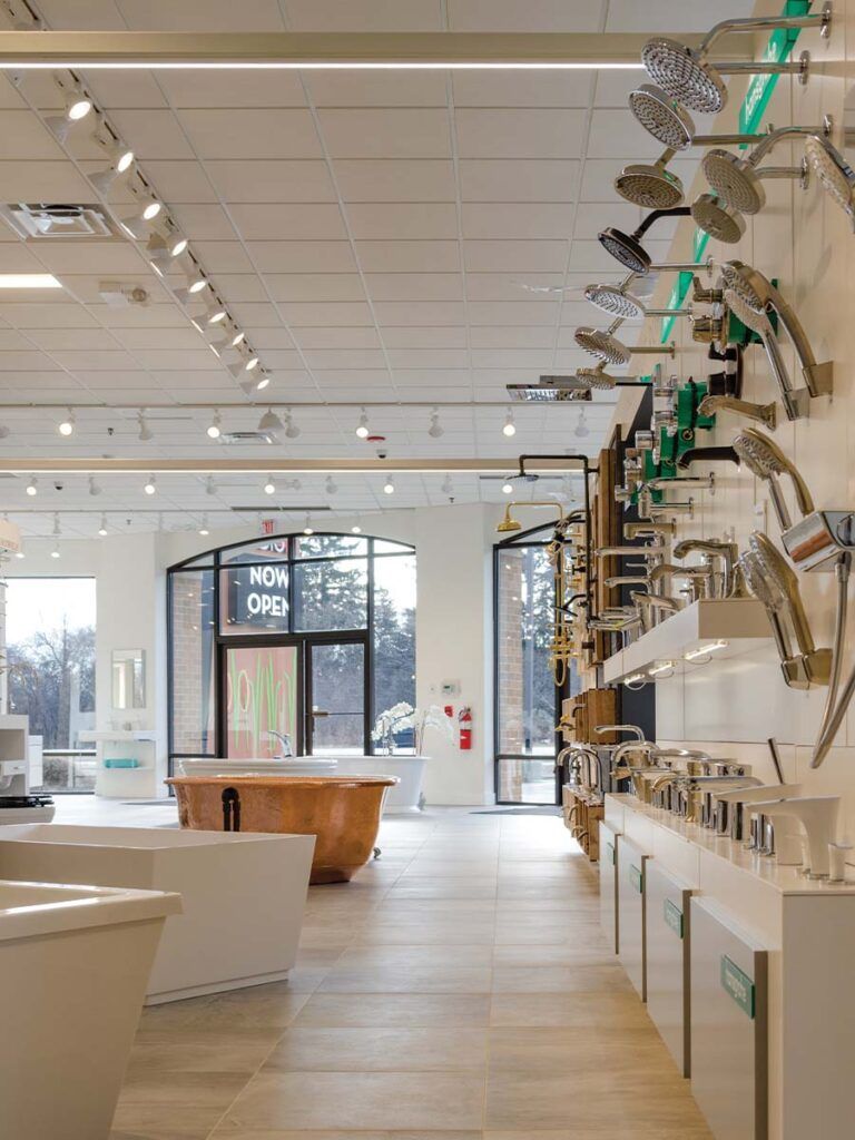 A shot of a Studio41 showroom with freestanding tubs, showerheads, and faucets.