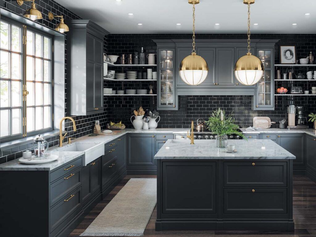 a dark and sophisticated kitchen with a farmhouse sink, hanging pendant lighting, and gold fixtures, featuring the Locarno collection by Hansgrohe.