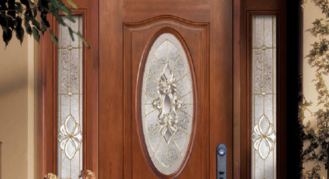 Close up on an Allure door with wood stain, side lites, and circle windows.