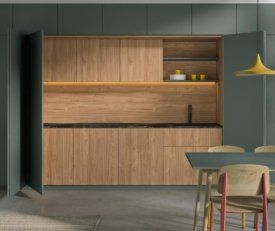 dark green and natural walnut cabinetry in a modern kitchen