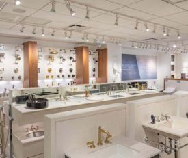 Wide angle shot of Kohler Hubbard's back room with all of their sinks, showers, and faucets