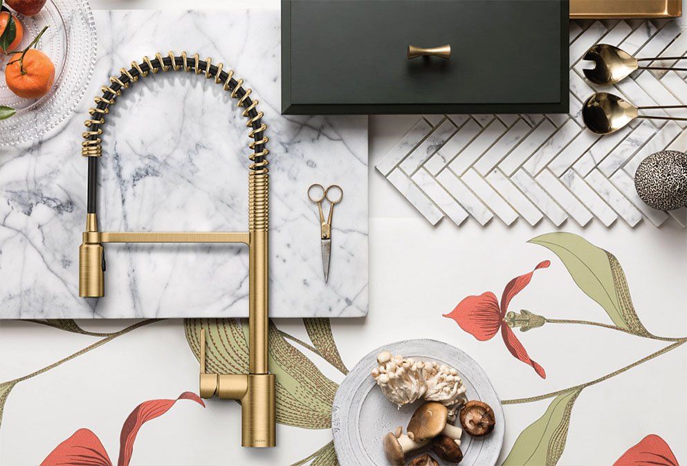 flatlay feauturing a polished brass semi professional moen kitchen faucet