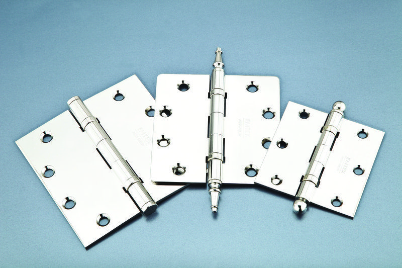 Three chrome Emtek hinges with various tips on a blue background