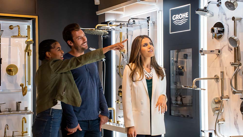 a studio41 product expert helping a young couple choose their new shower