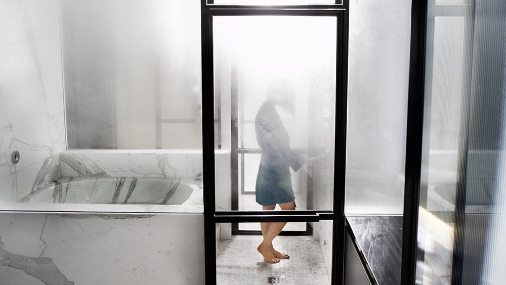 a woman enjoying her steam shower by mr steam