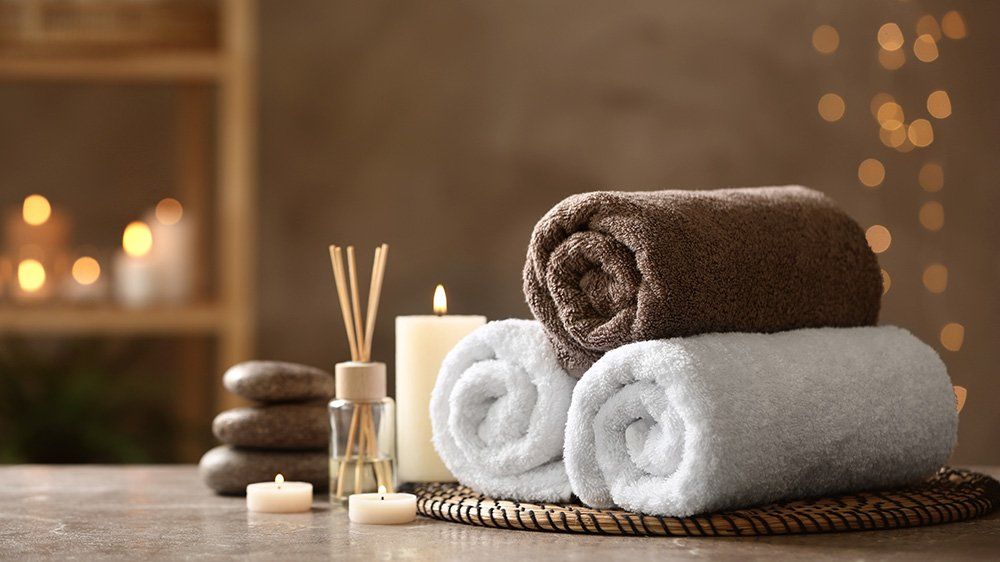 rolled towels and candles creating a spa like atmosphere