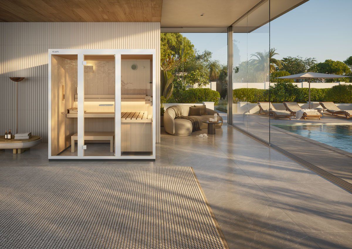 A stylish in home klafs sauna adjoining a pool