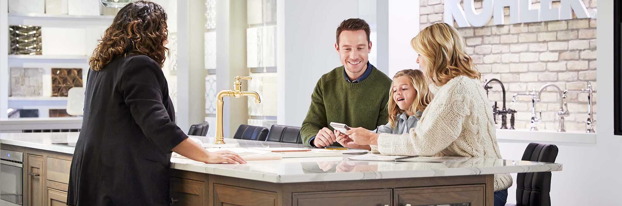 A Studio41 expert meets with a family in a showroom to discuss their renovation.